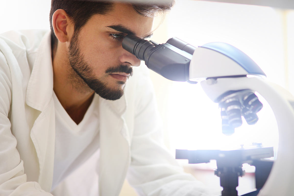 Scientist looking in to microscope